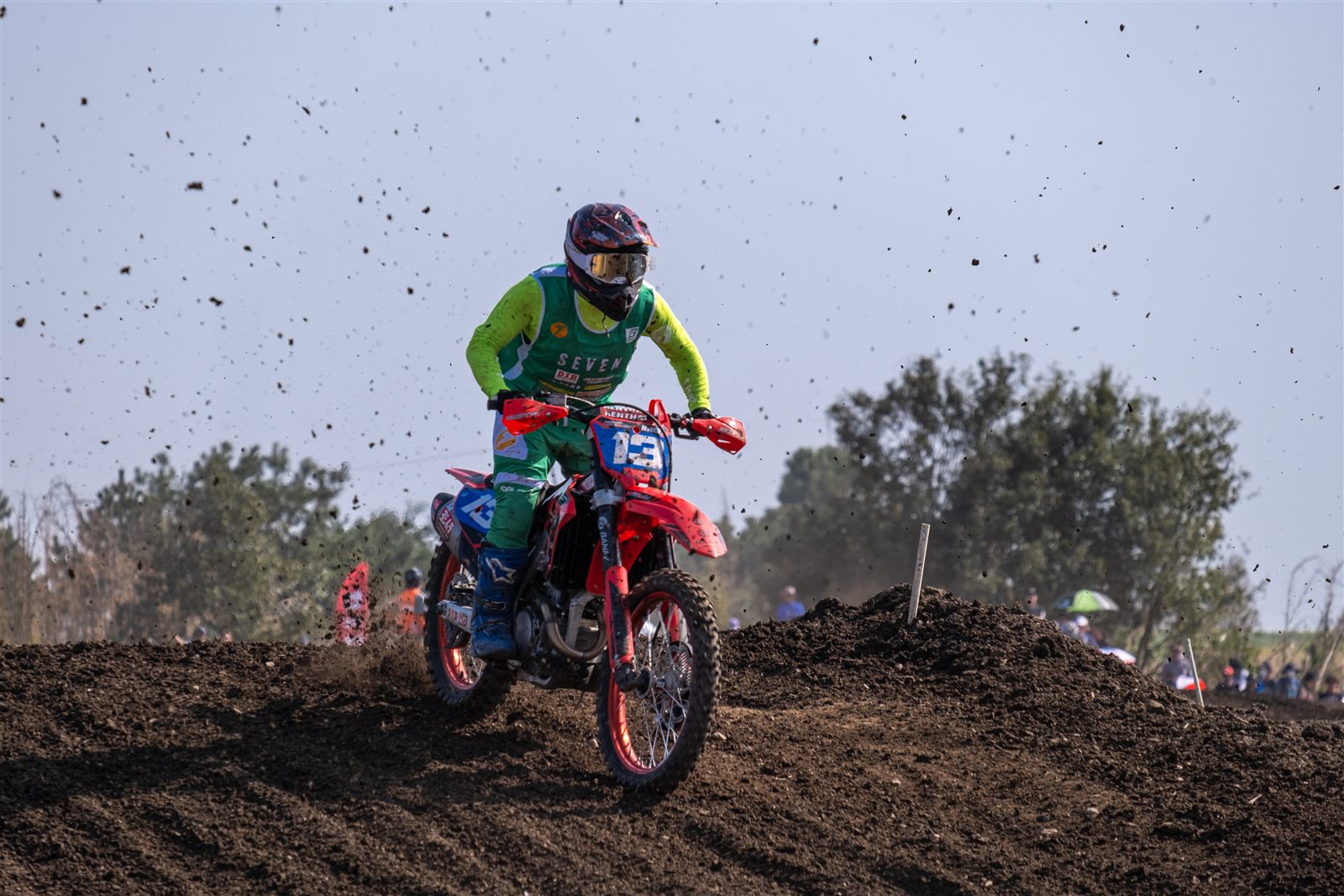 Motocross rider kicking up dirt on a track