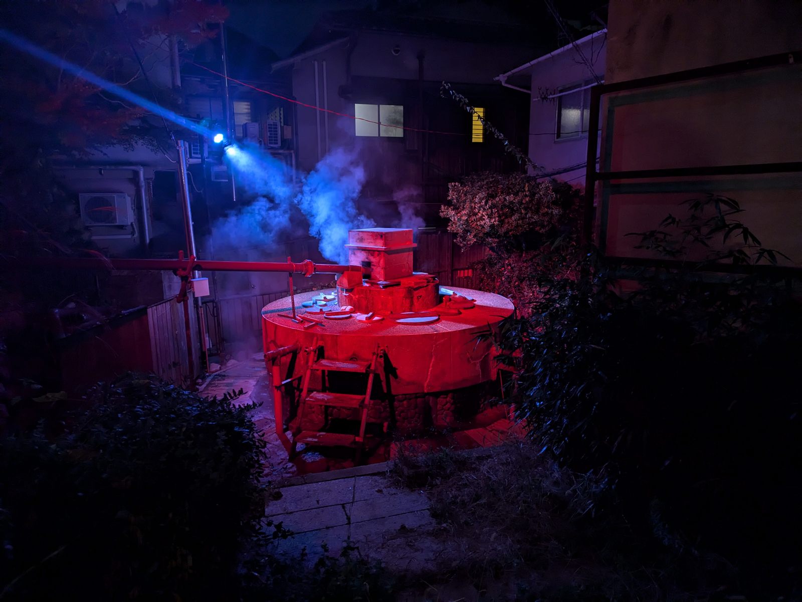 Blue and red light cutting through smoke at night